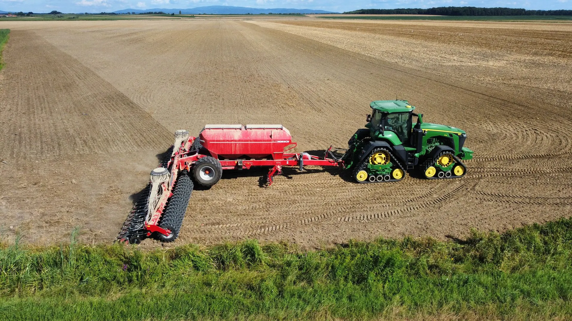 Traktor vetőgéppel a tábla fölött, drónfelvételen